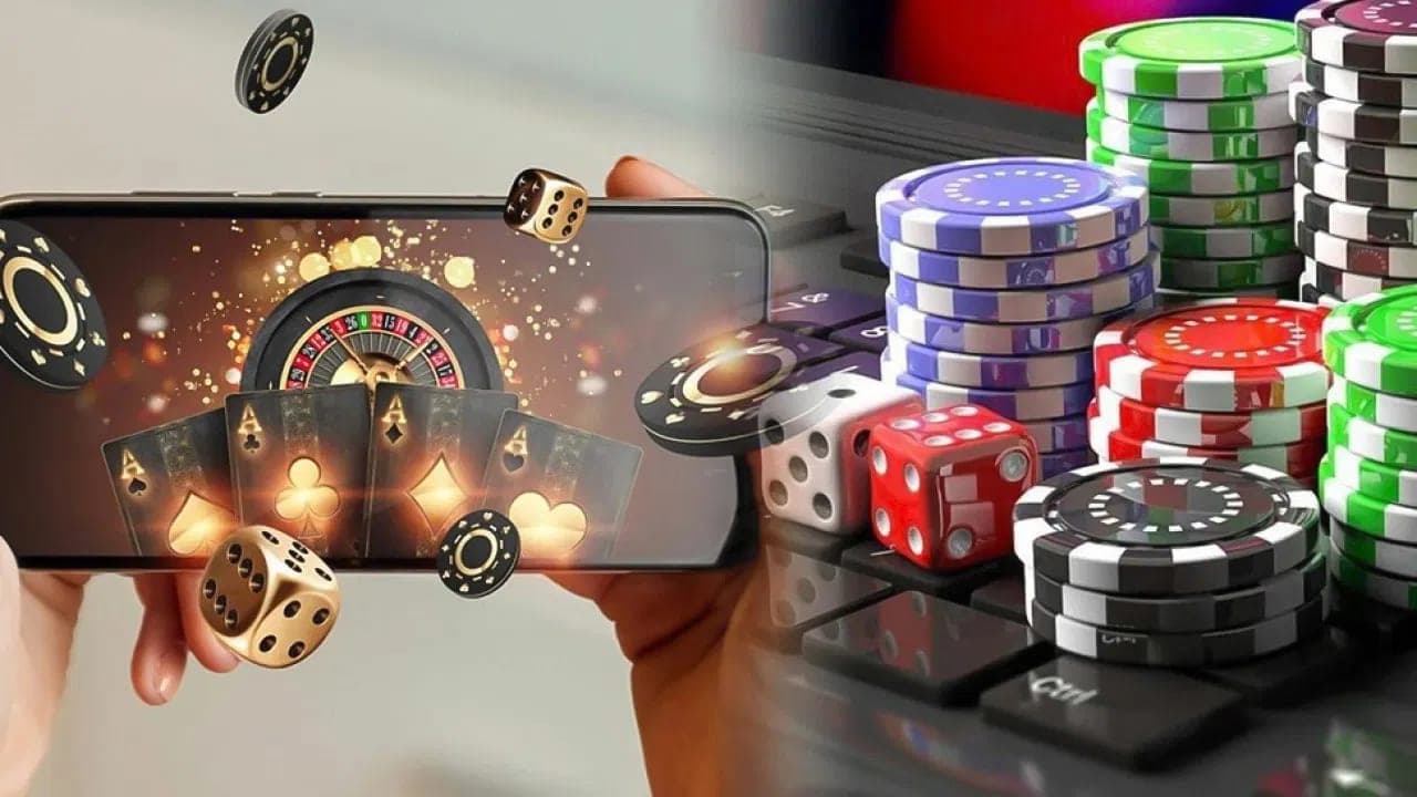A smartphone showing a casino game beside stacks of gaming chips and dice