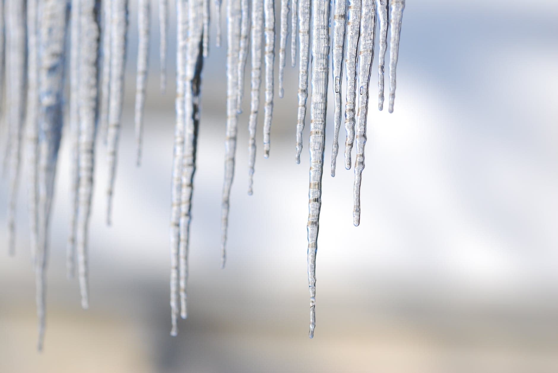 Icicles hanging against a pale winter sky